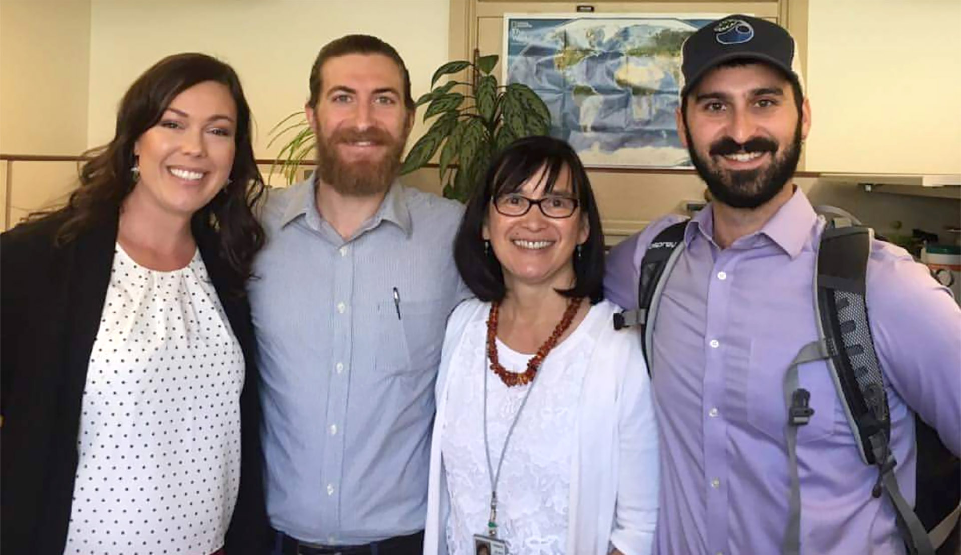 Four people standing together