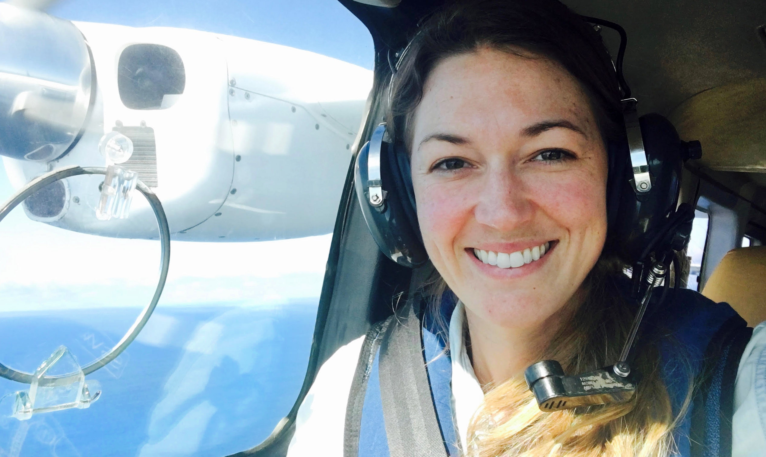 Smiling woman in plane passenger seat