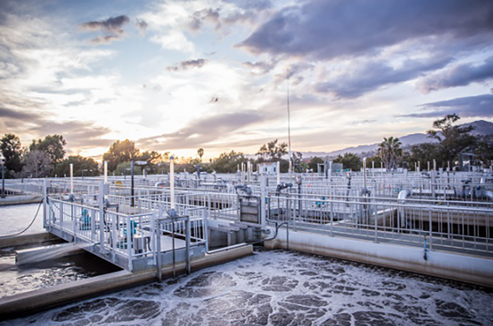 Sunset over wastewater treatment tanks