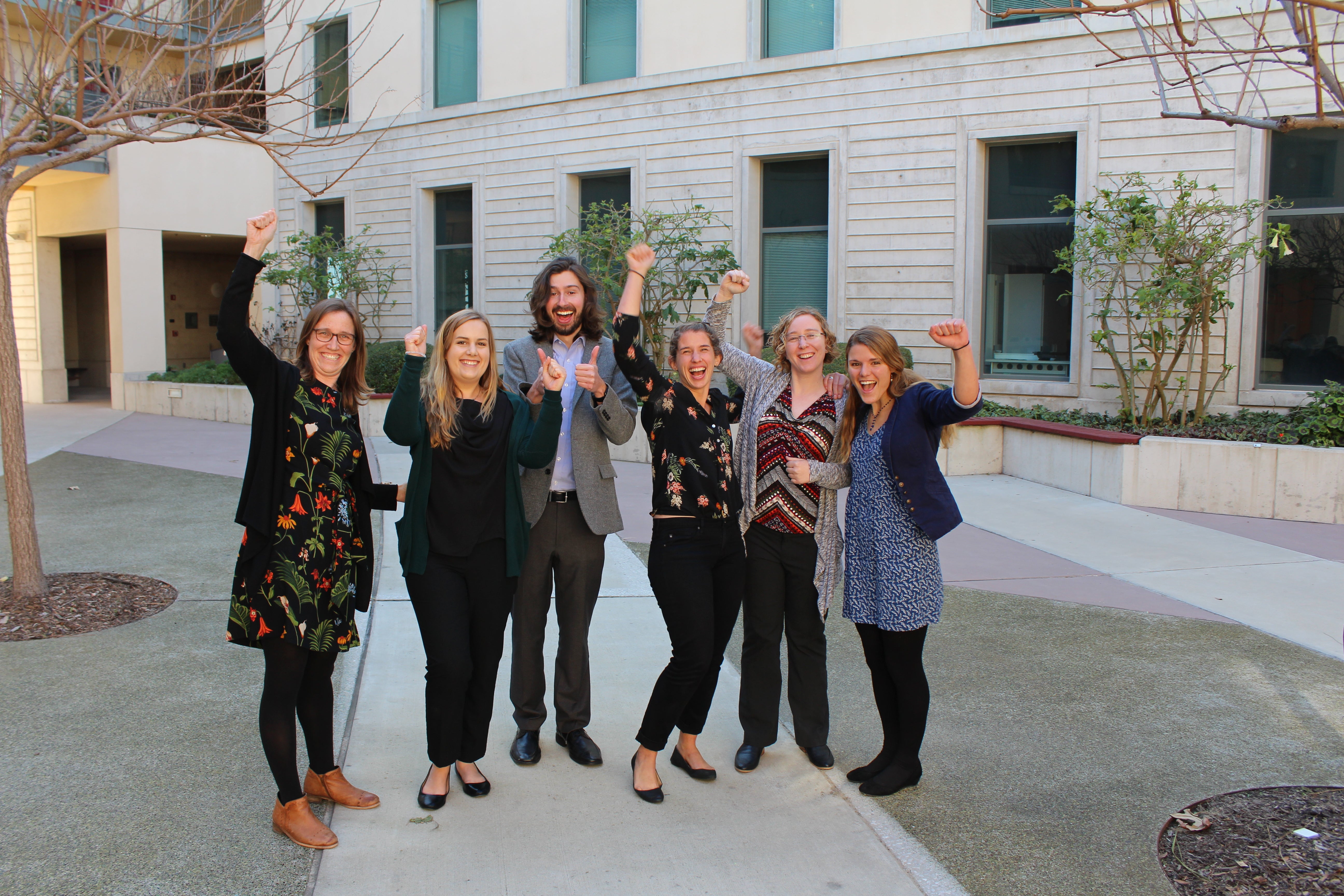Group of six people cheering