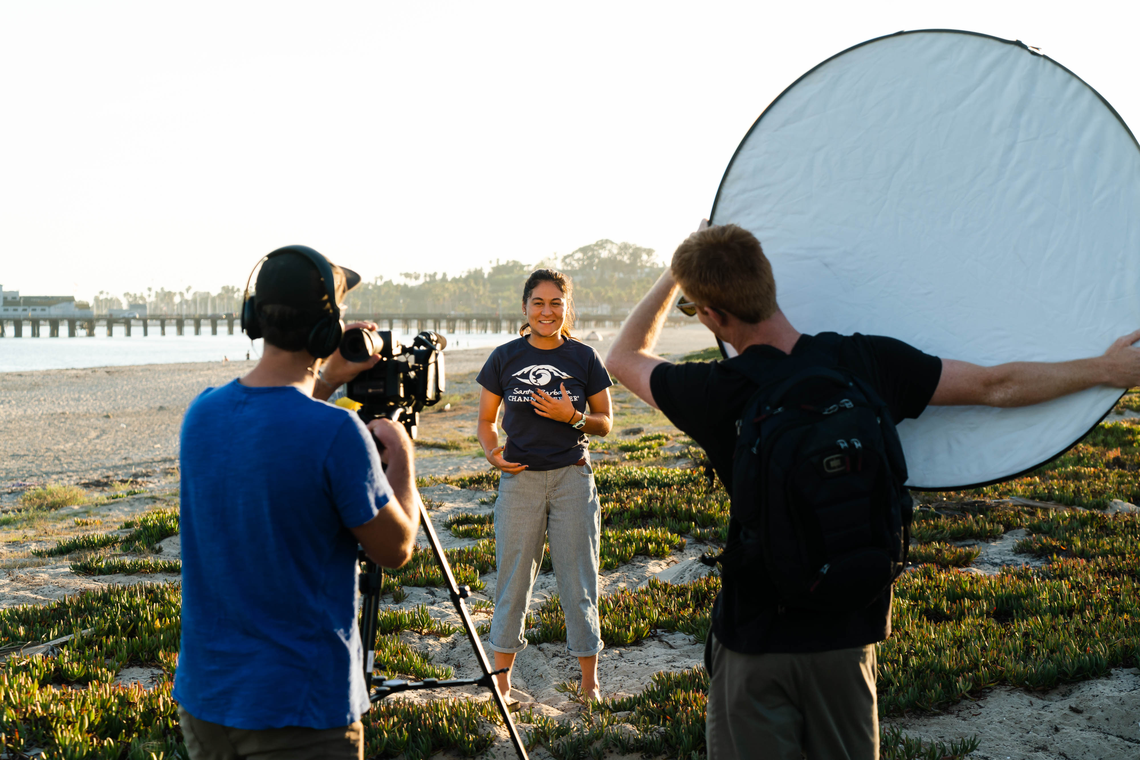 Three students shooting a video on the beach