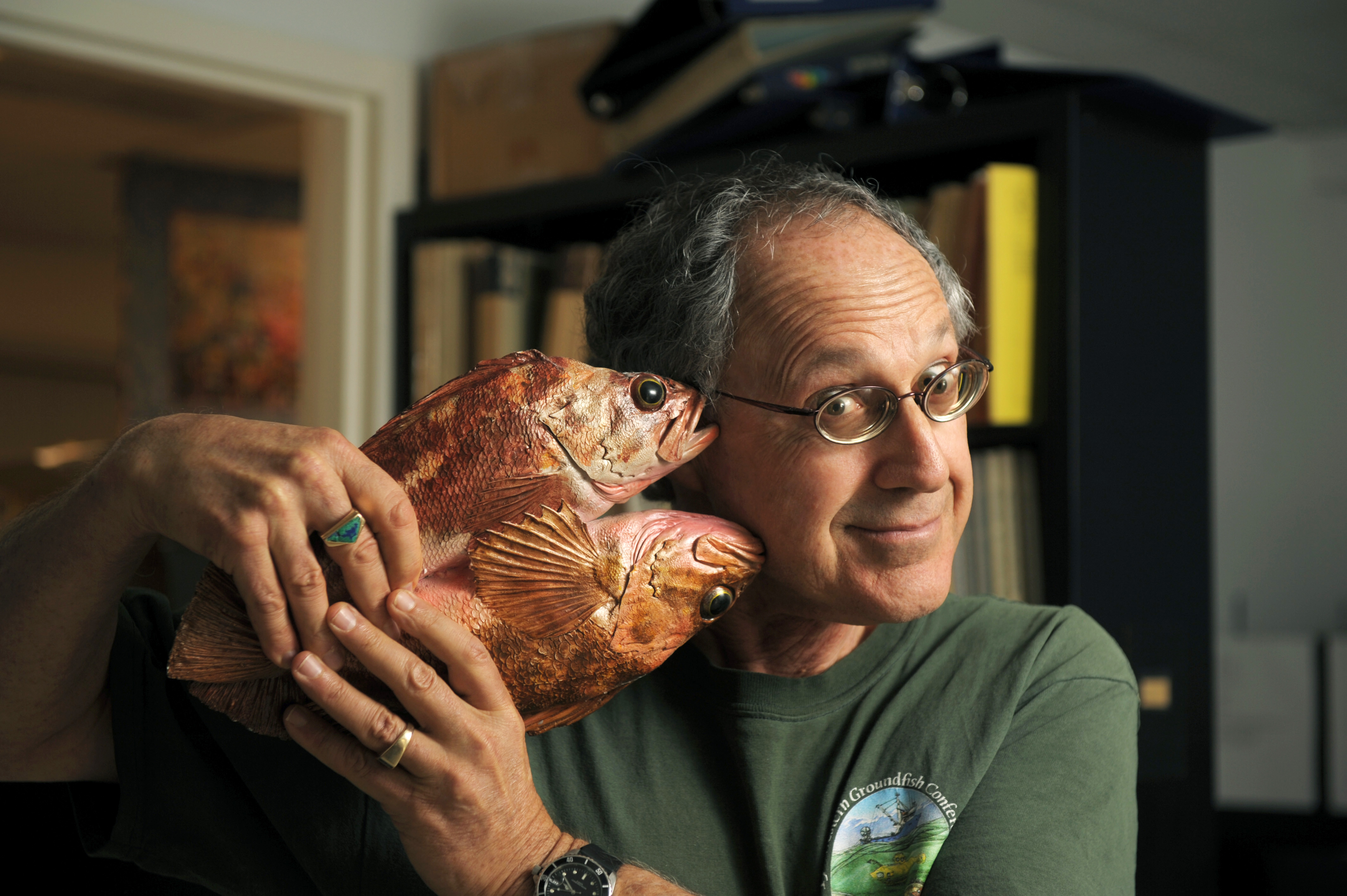 Milton Love holds a fish to his cheek