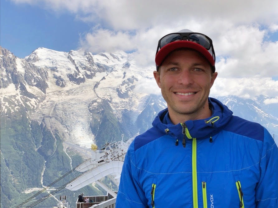 Ty Brandt in front of a snowy mountaintop