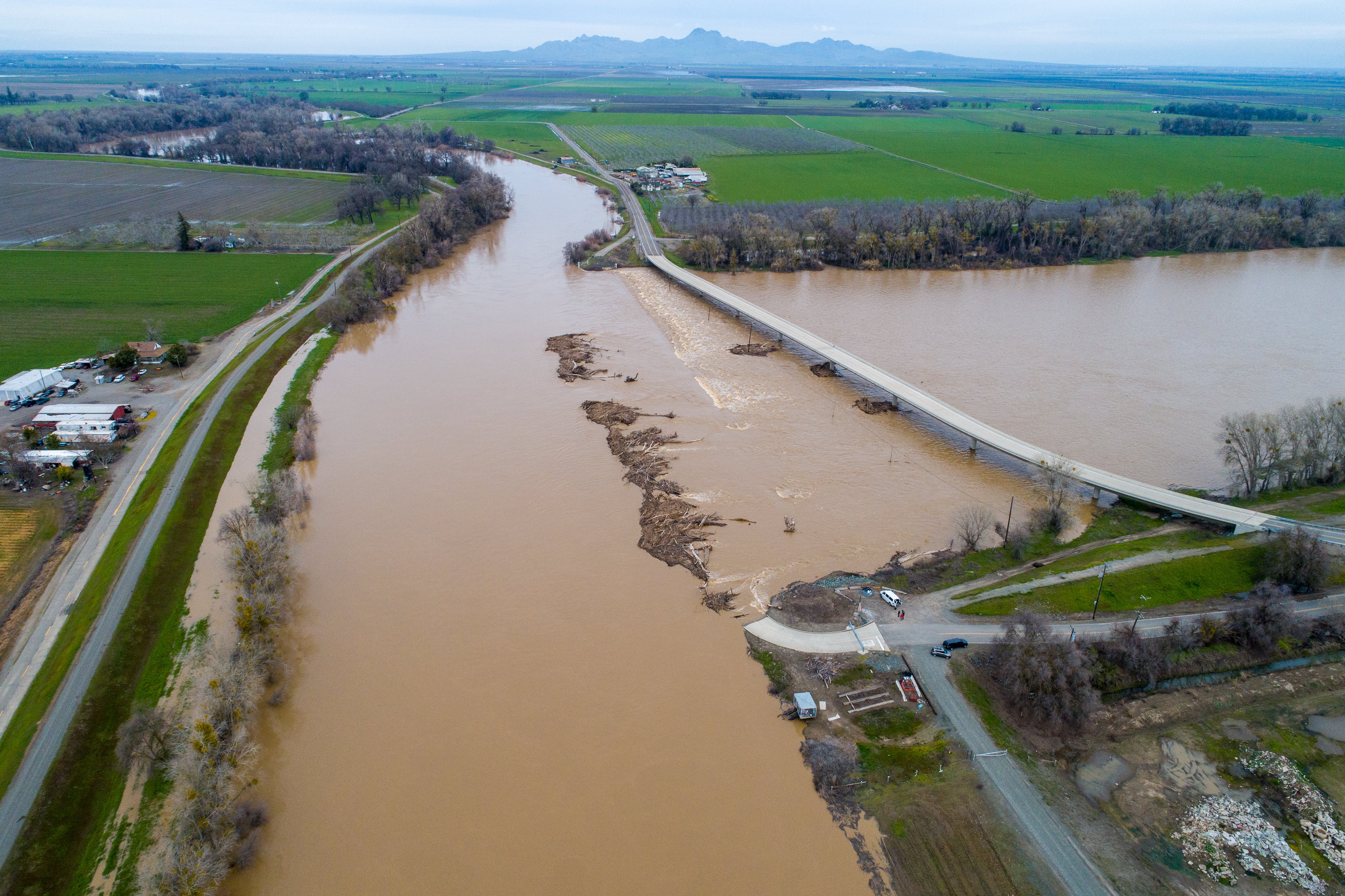 Sacramento River flooded into farmlands and highway