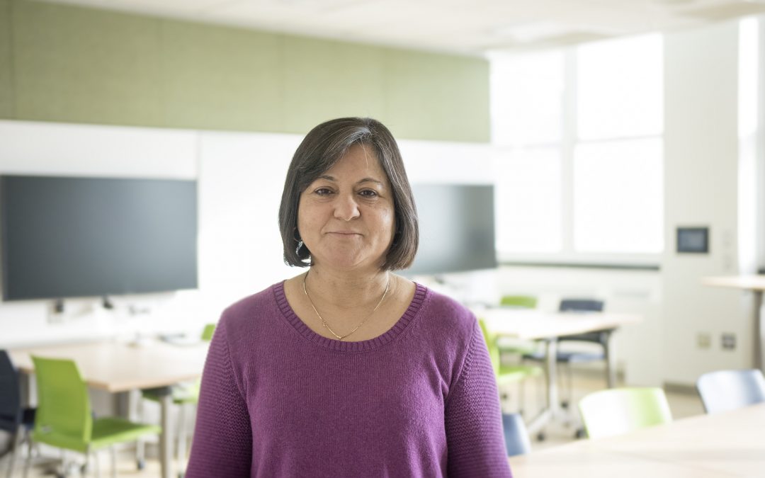 Madhu Khanna stands in a classroom