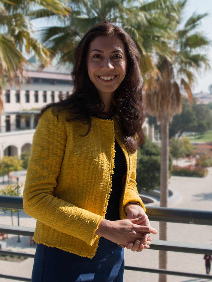 Newsha Ajami stands on a balcony