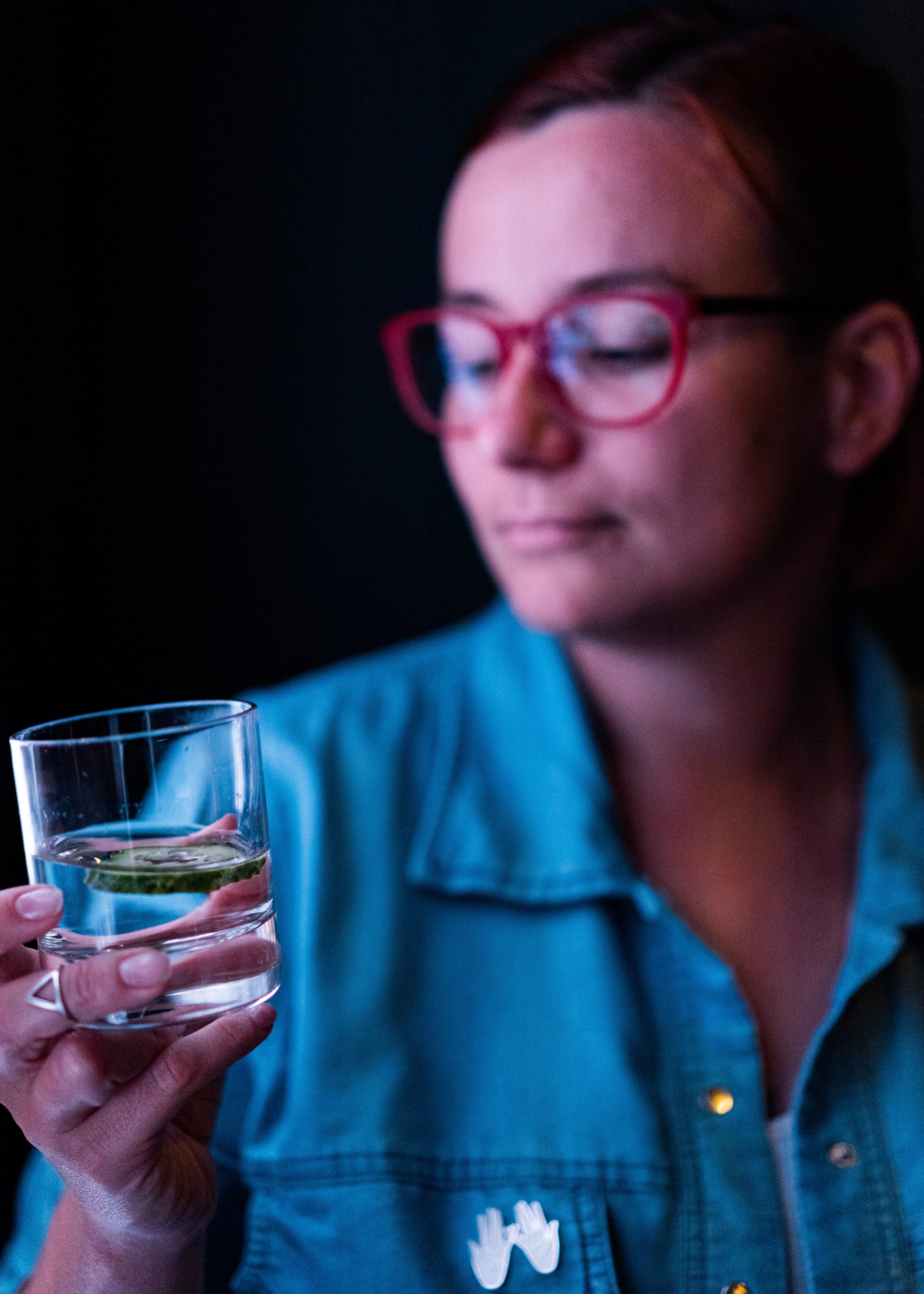 Woman holding glass of water