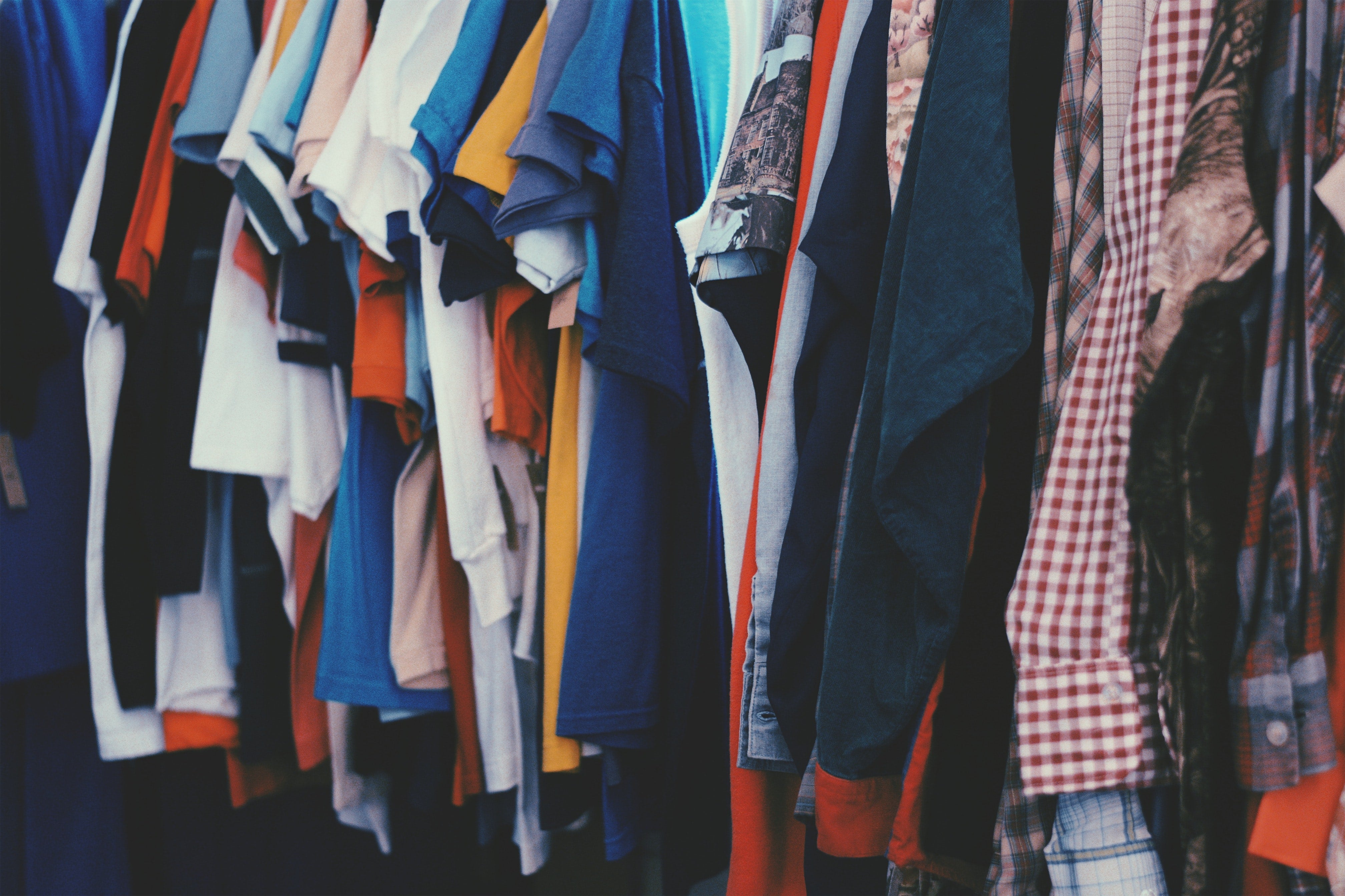 Colorful clothing hanging in a closet