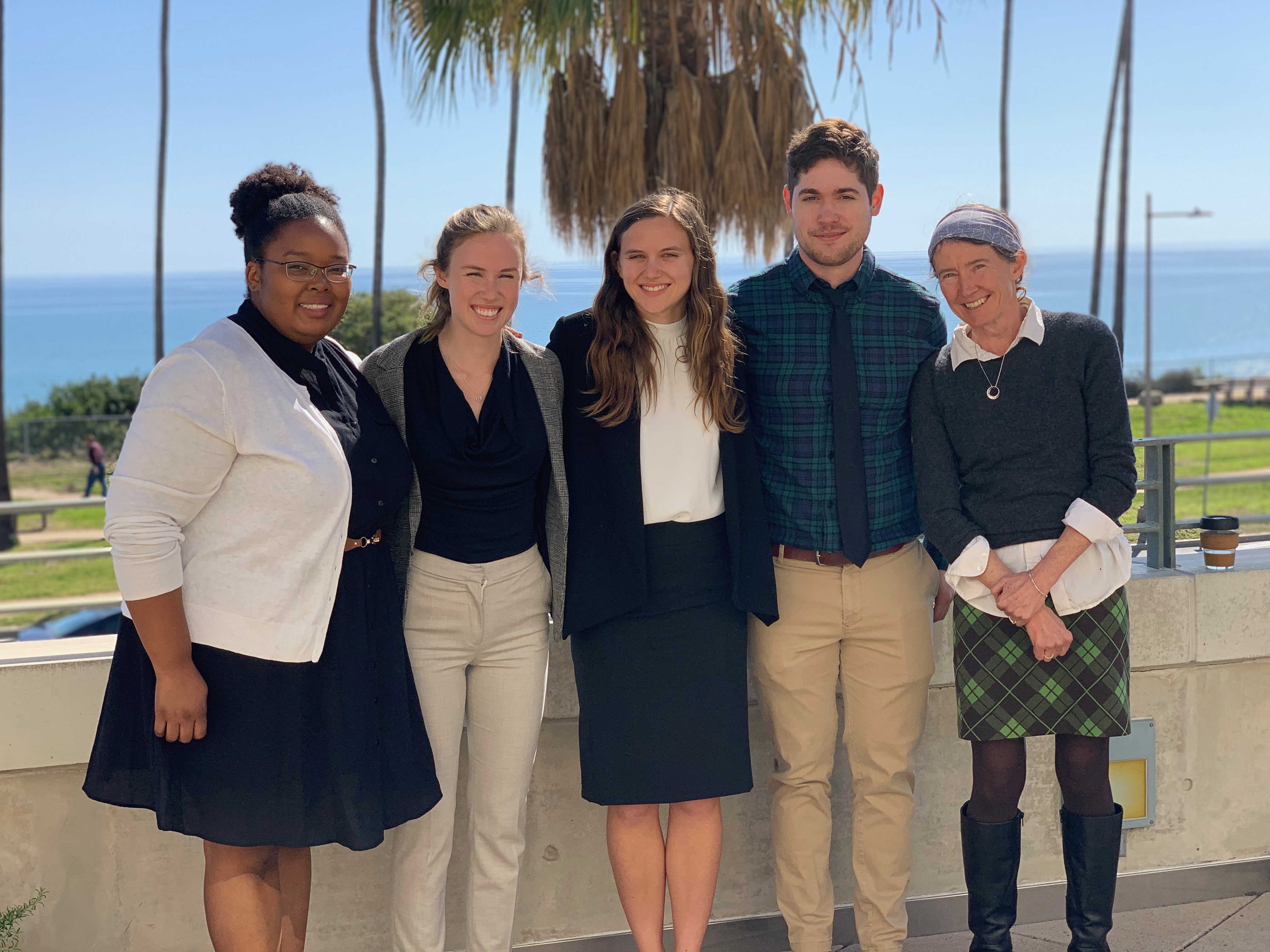 four students standing with faculty mentor