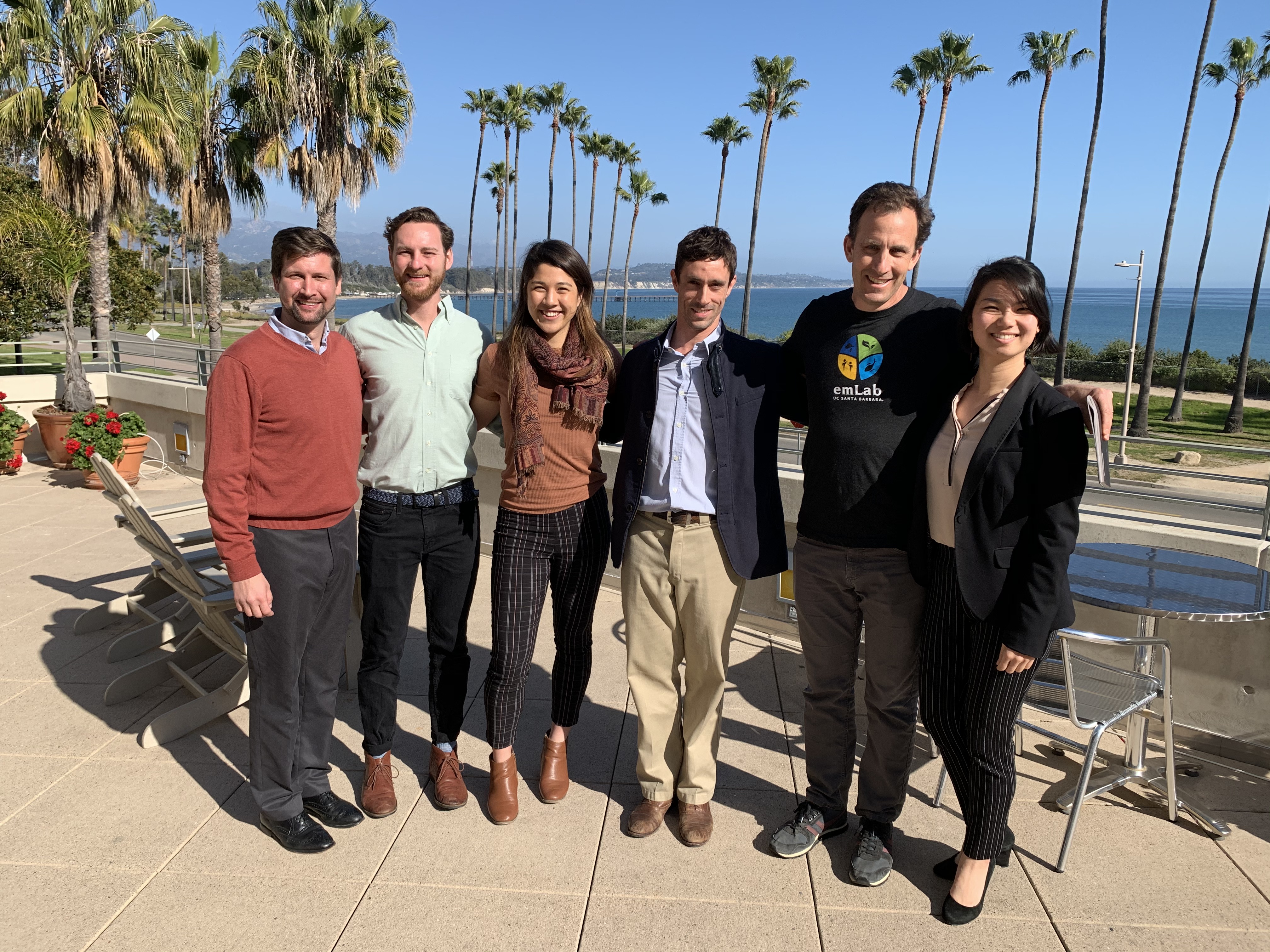 Group of five students with faculty mentor on outdoor terrace