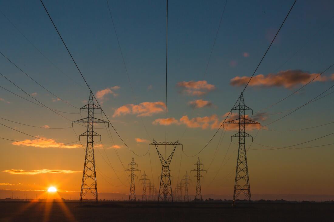 Sunset behind large electrical towers