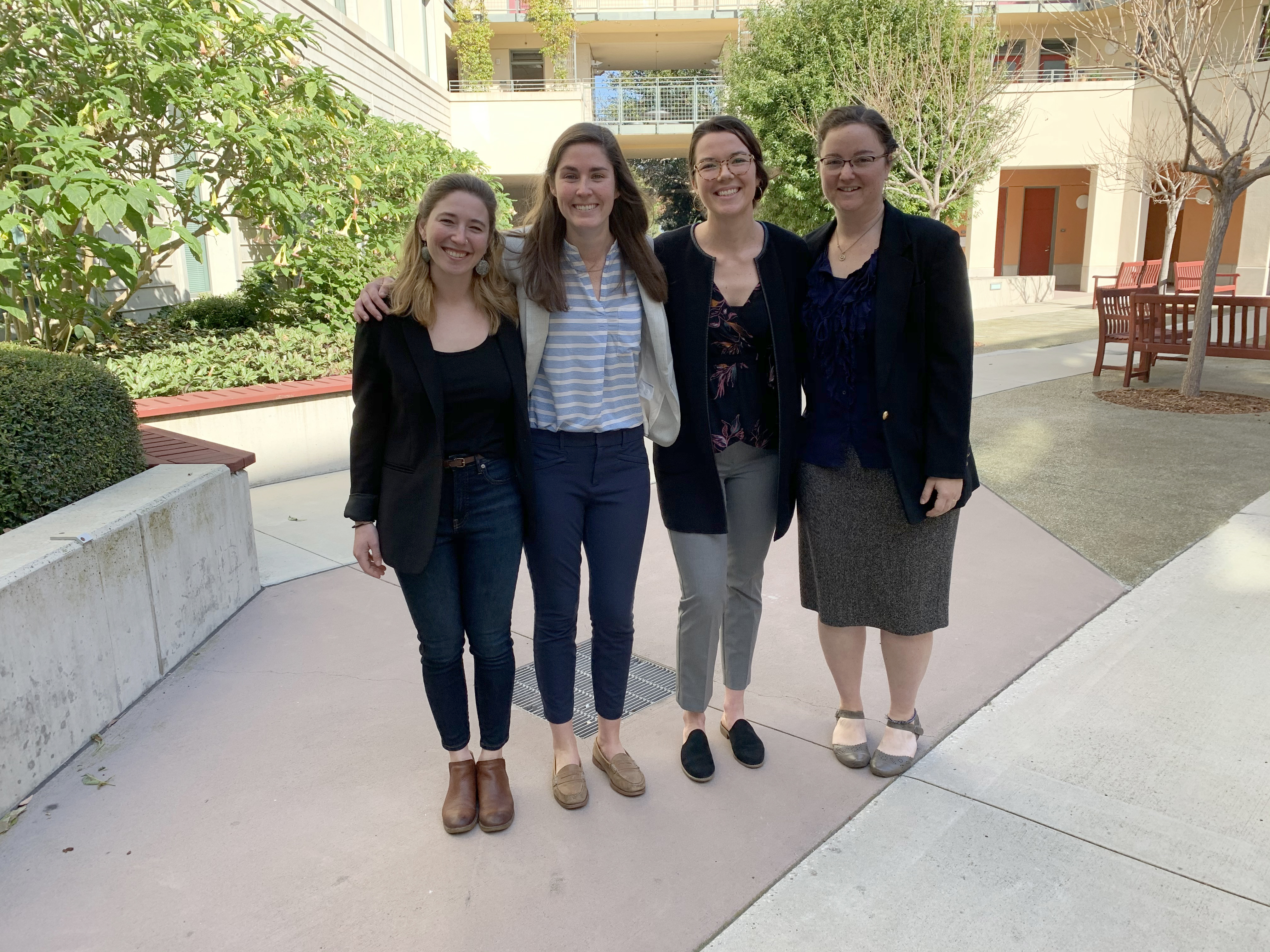 Four students smiling together