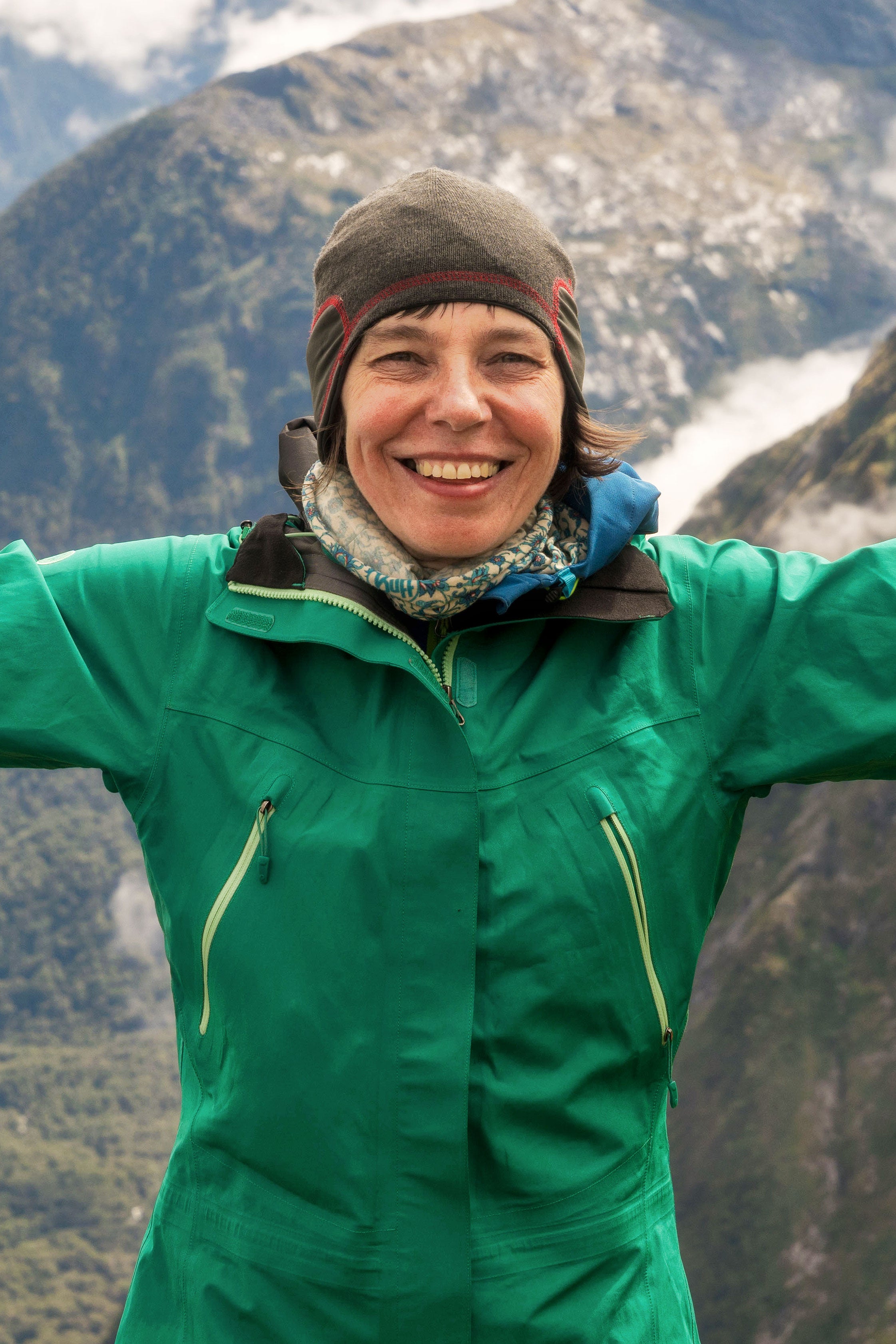 Małgorzata Grodzińska-Jurczak stands with arms wide outdoors