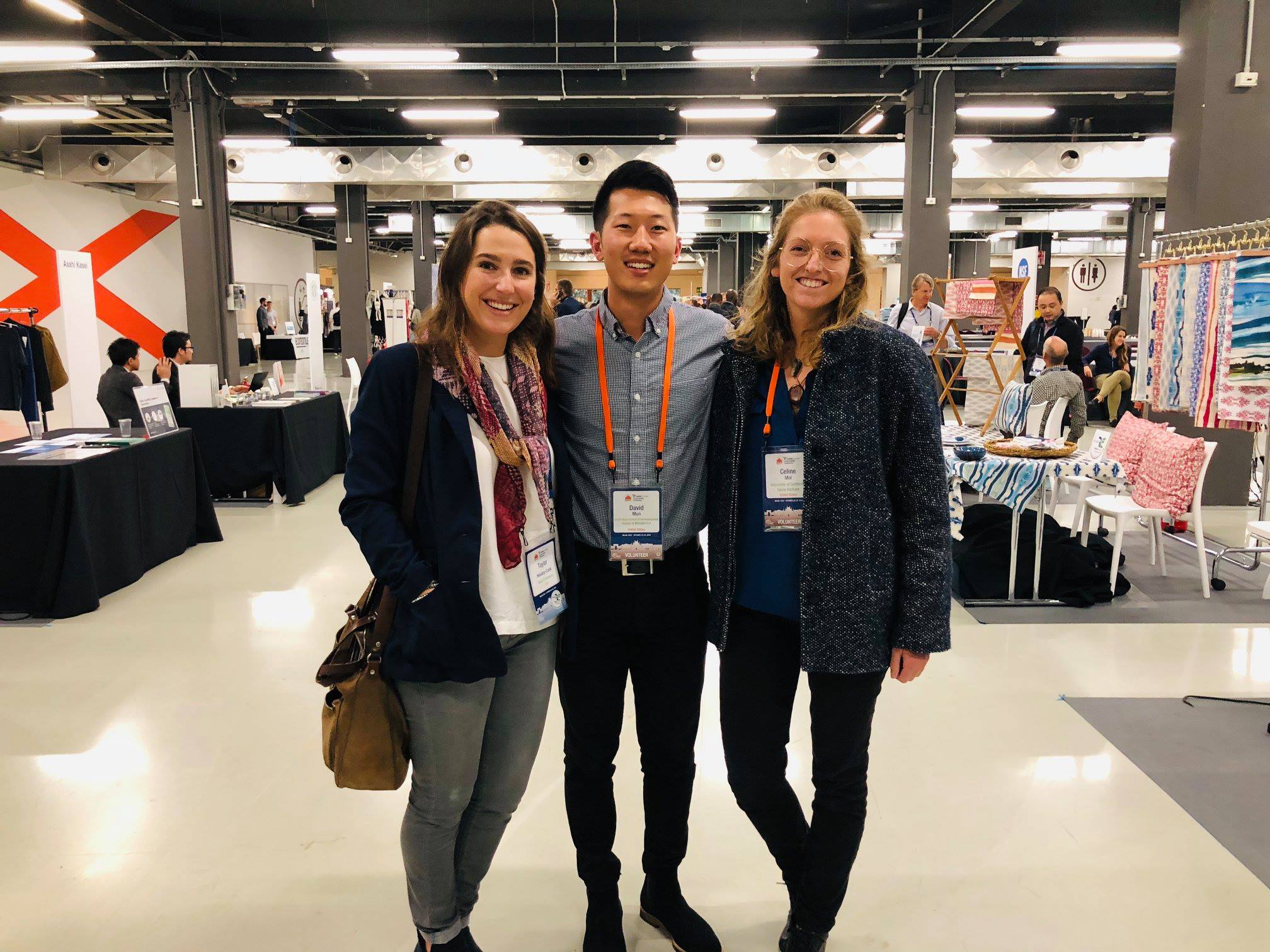 Three students pose together in a convention hall