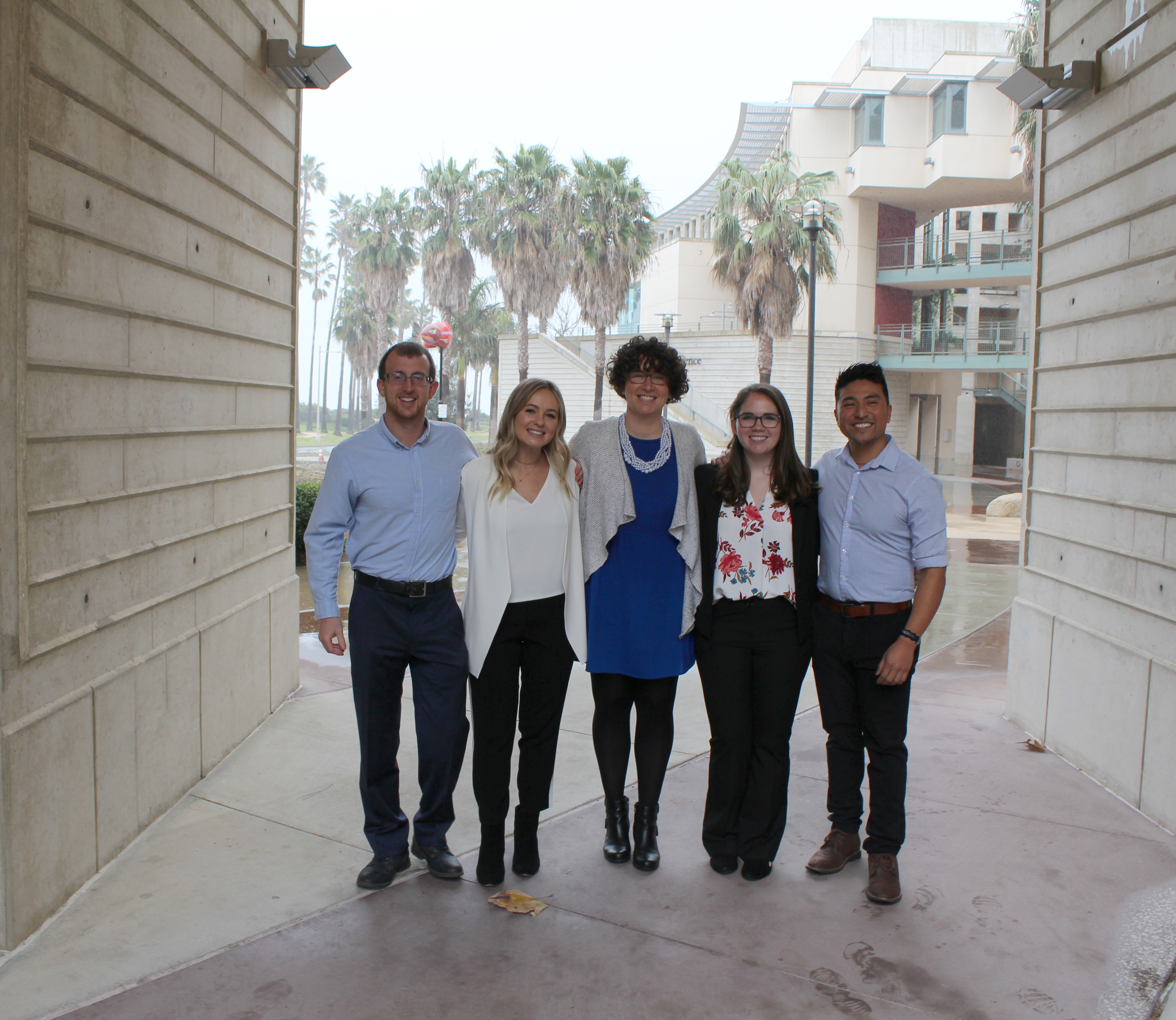 Five students posing together for a photo