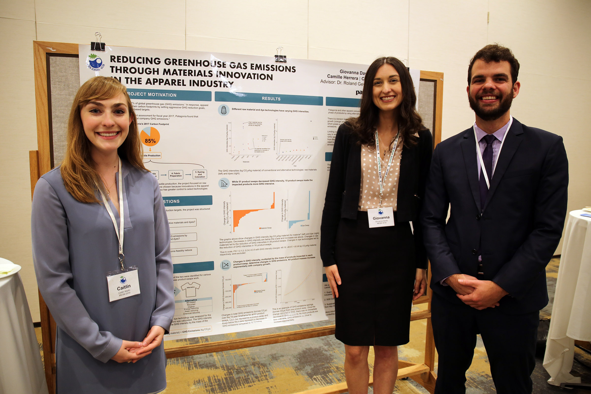 Three students standing in front of a project poster