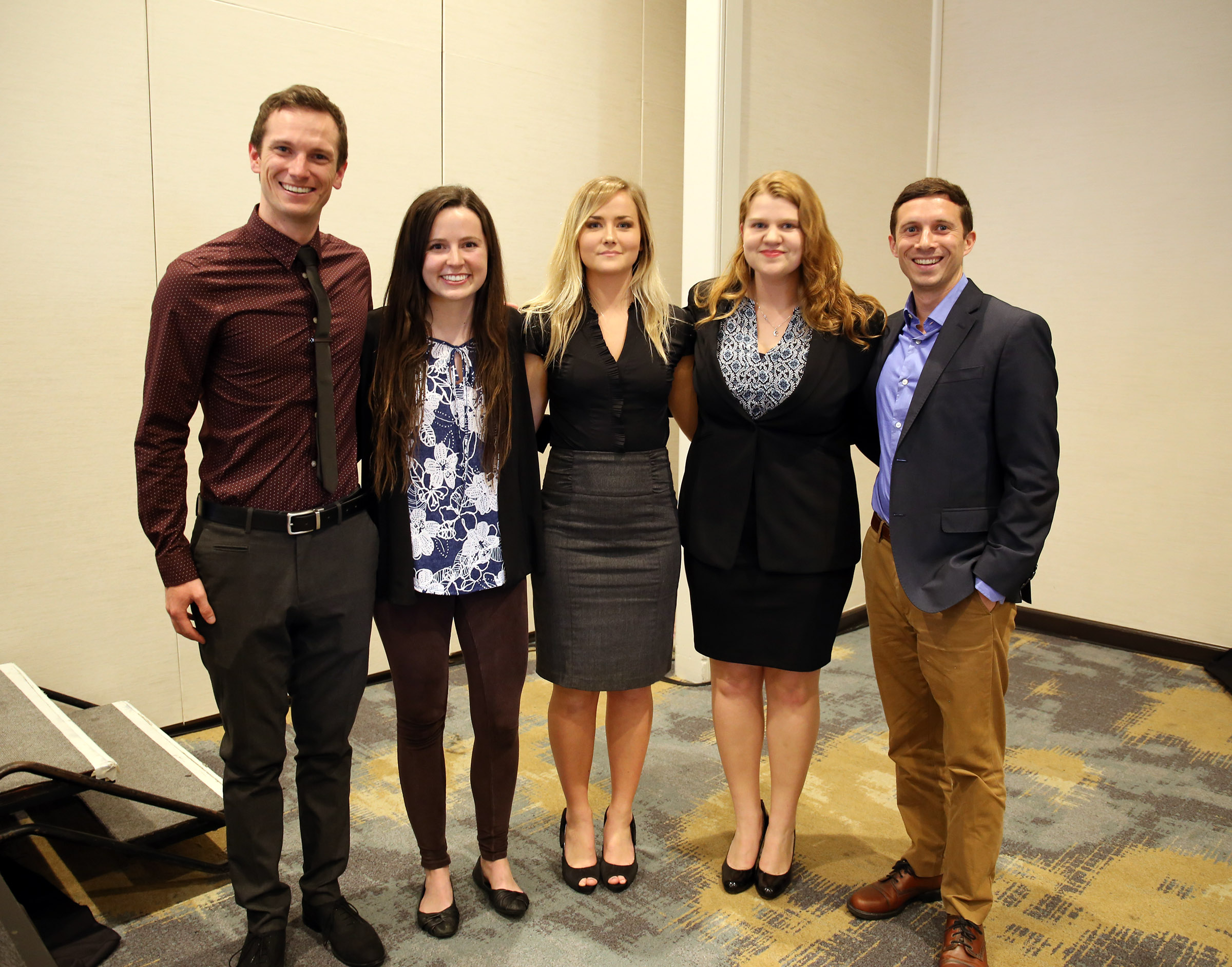 Group of five students posing together