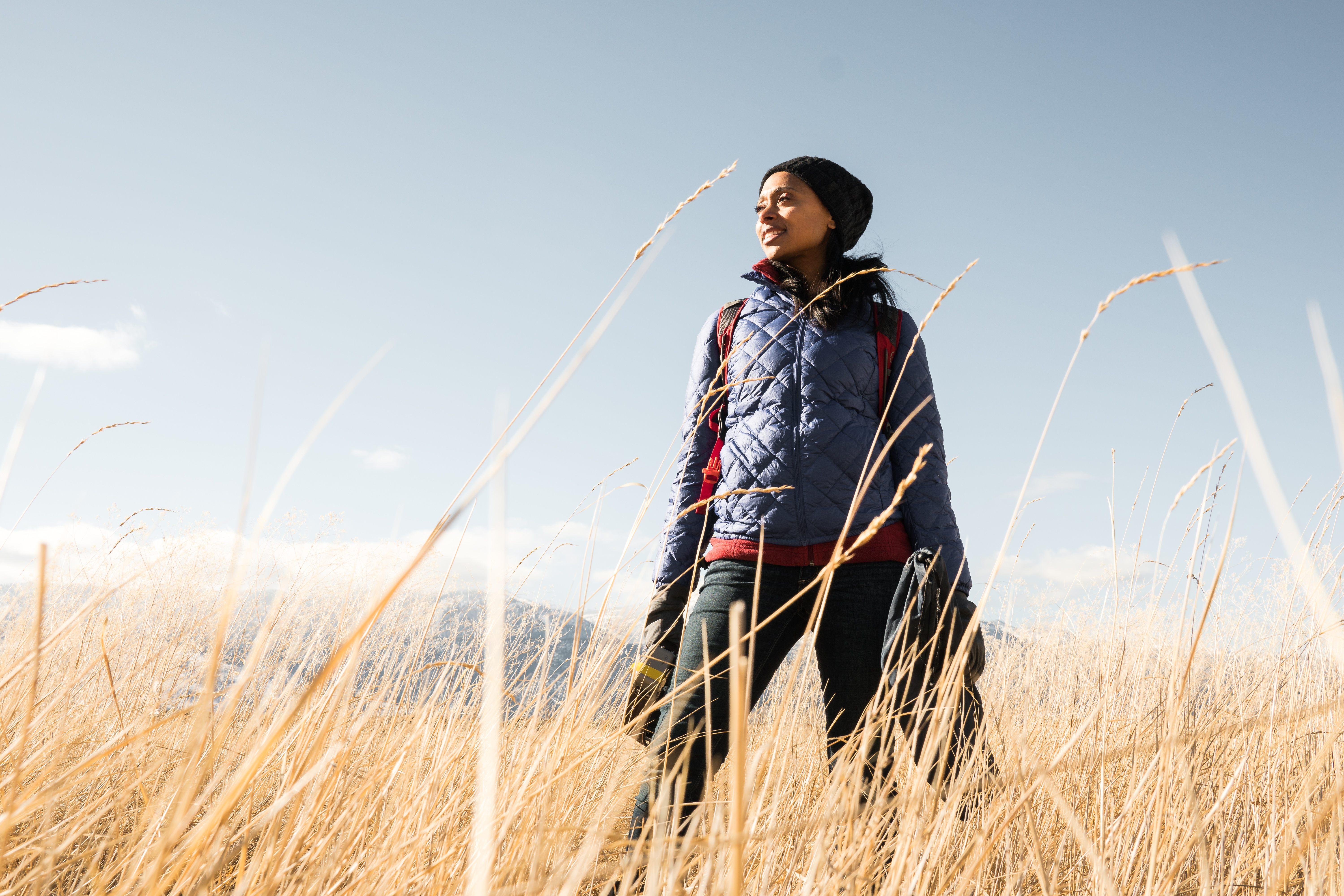 Dr. Rae Wynn-Grant standing in field of tall grass