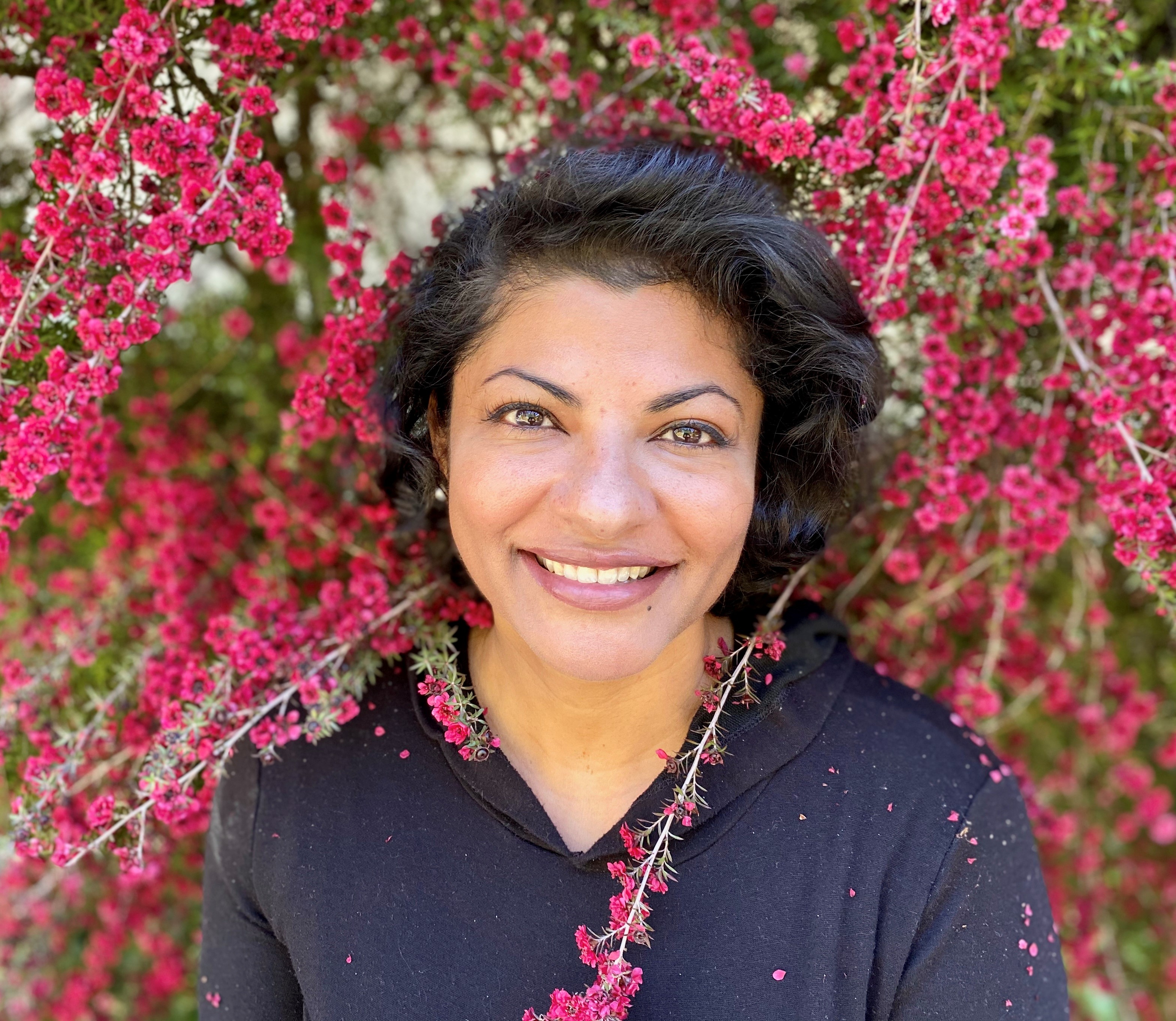 Woman standing among flower branches