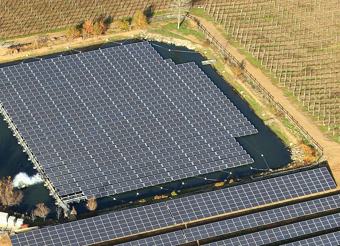 Aerial view of solar panels floating in pond