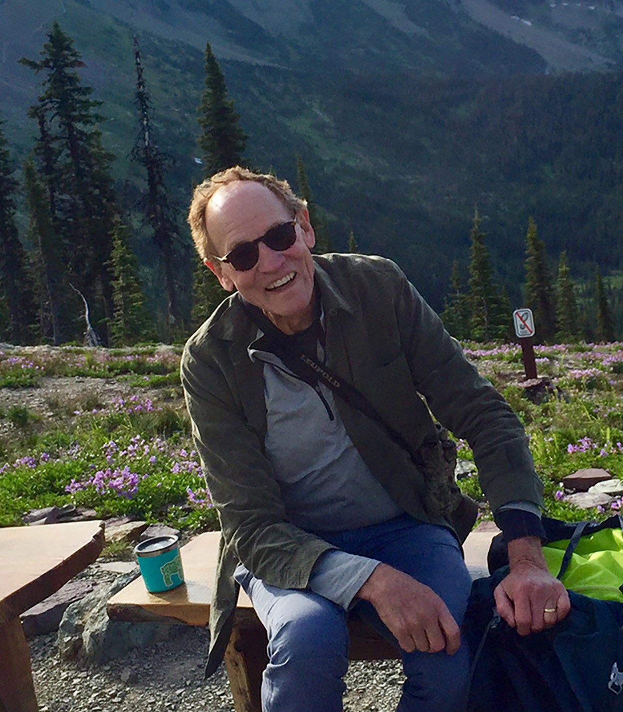 Man sitting on bench in meadow