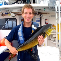 Person on boat holding large fish