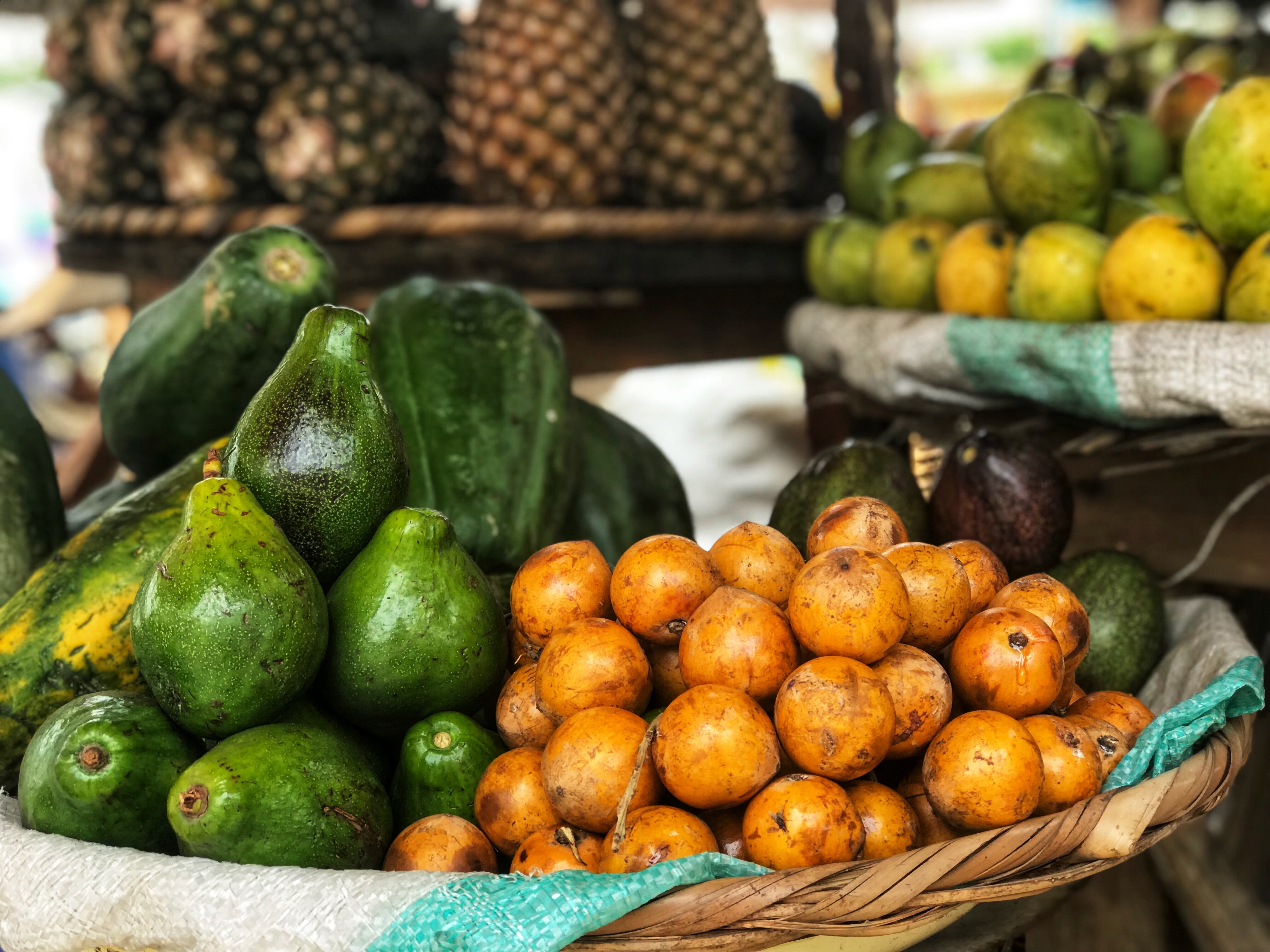 Fruits and avocados on market table