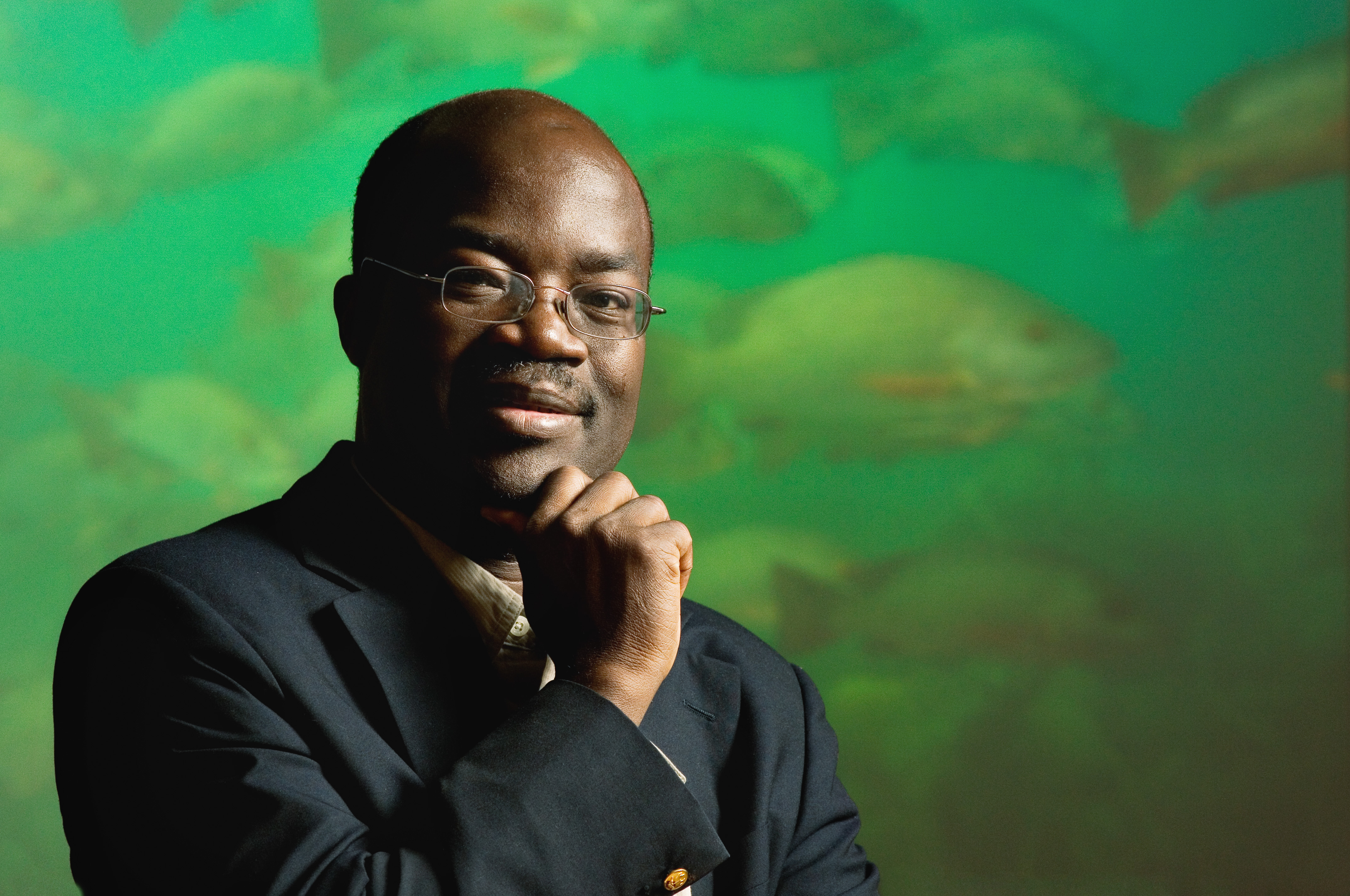 Rashid Sumaila in front of a green fish background