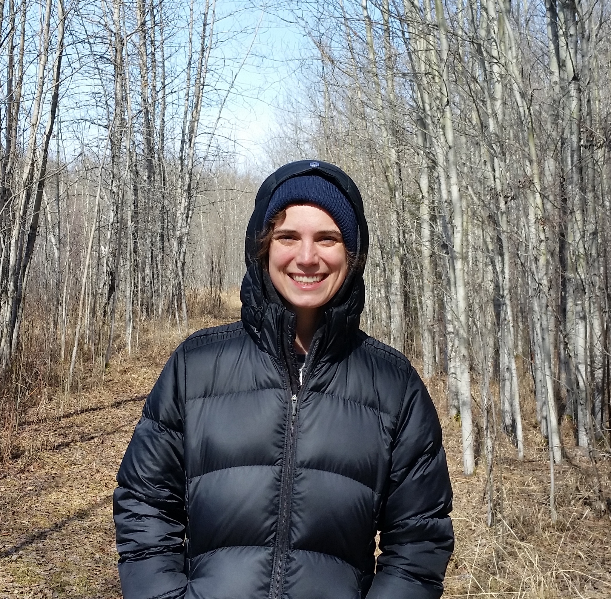 Ruth Oliver stands in the woods in a black jacket