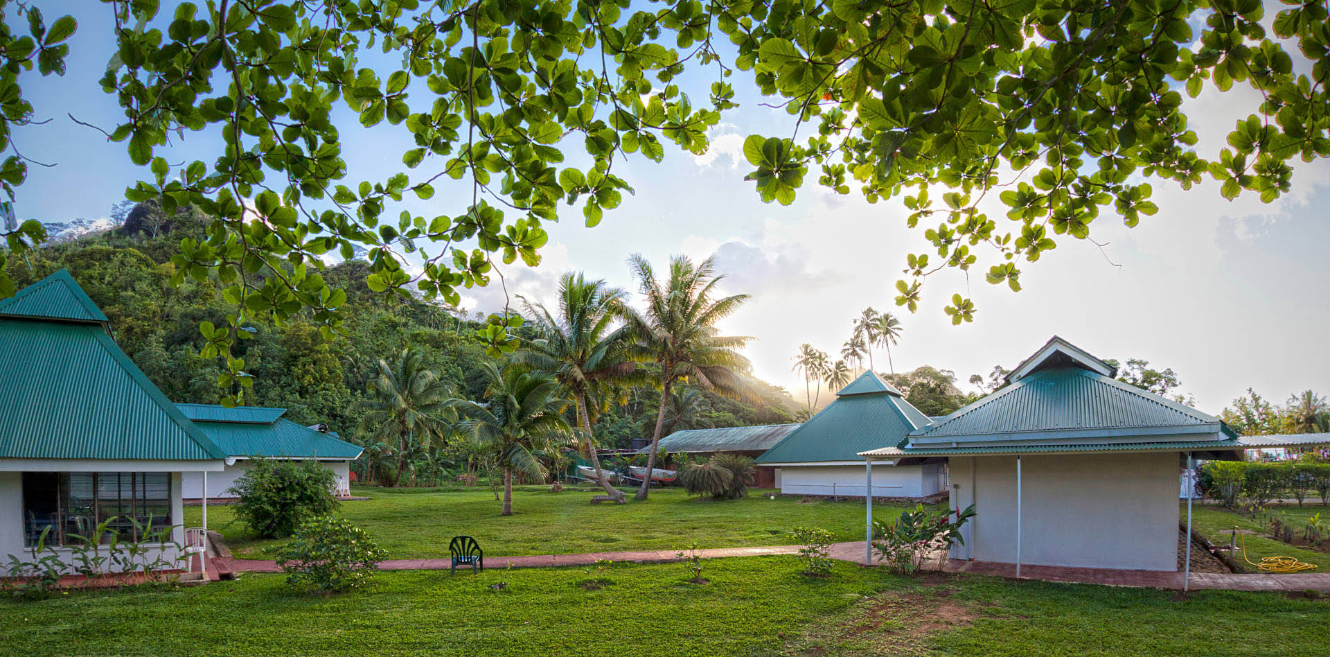 Small buildings in a grassy area with lush vegetation - the Centre for Island Research and Environmental Observatory