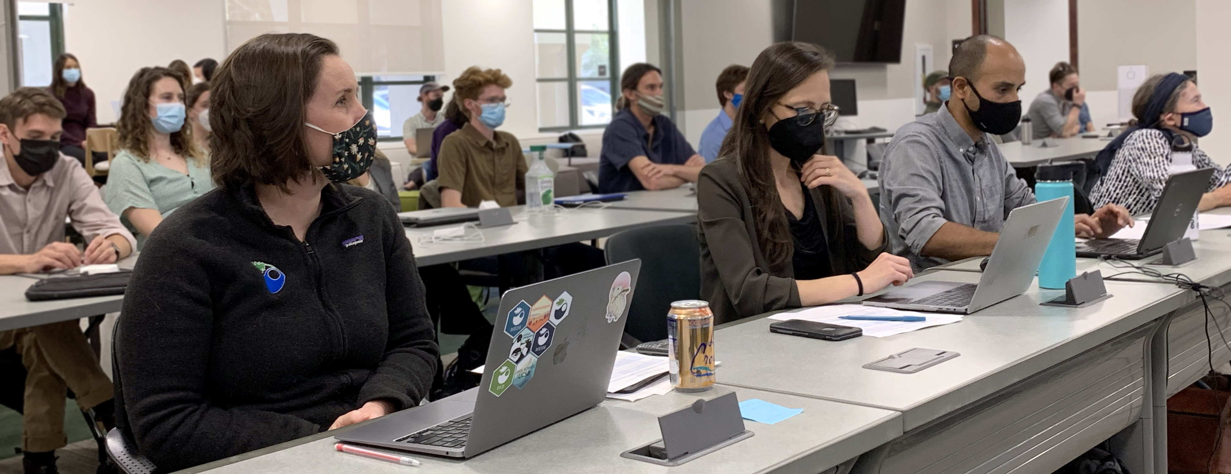 People sitting in classroom rows watching a presentation