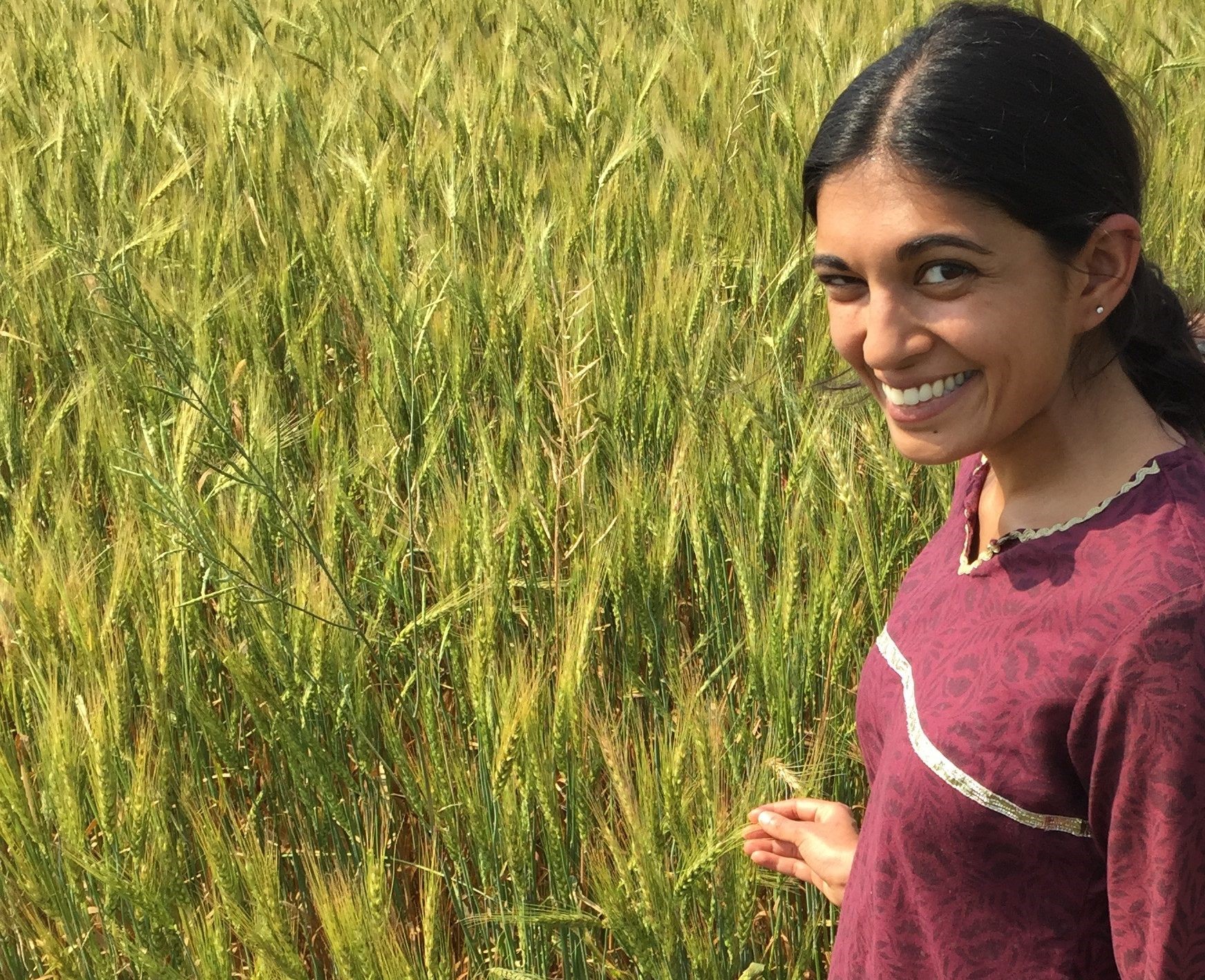 Meha Jain stands in a wheat field