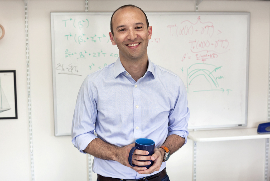 Solomon Hsaing stands in front of a whiteboard