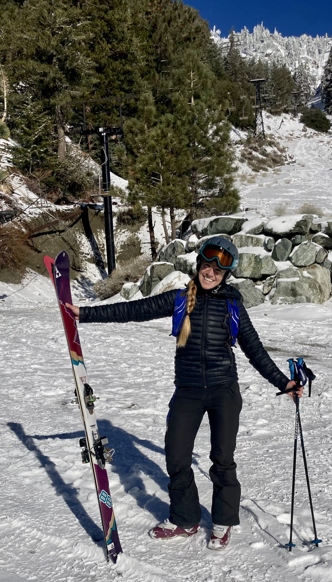 Laura Grant poses in ski gear on a snowy slope