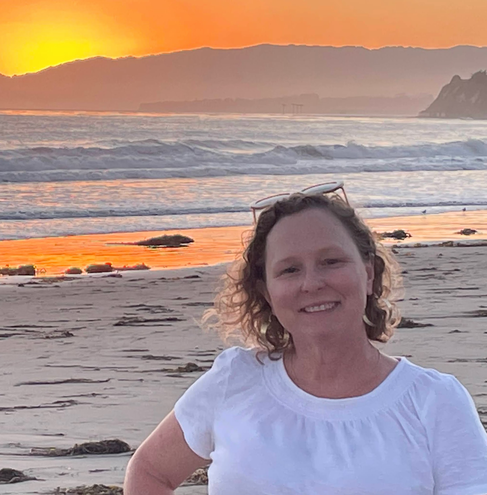 Cheryl Harrison on a beach at sunset