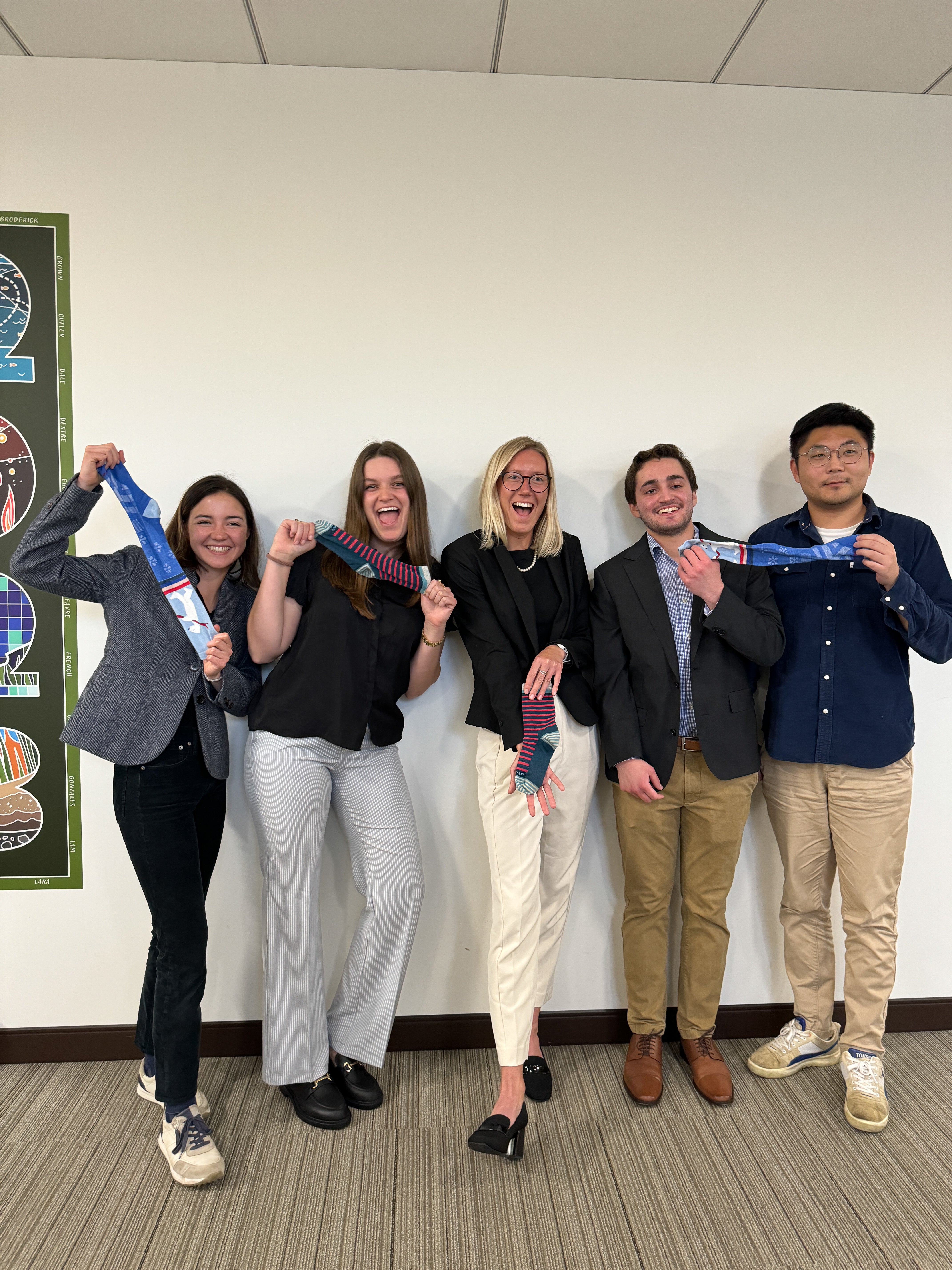 A group of students holds blue socks