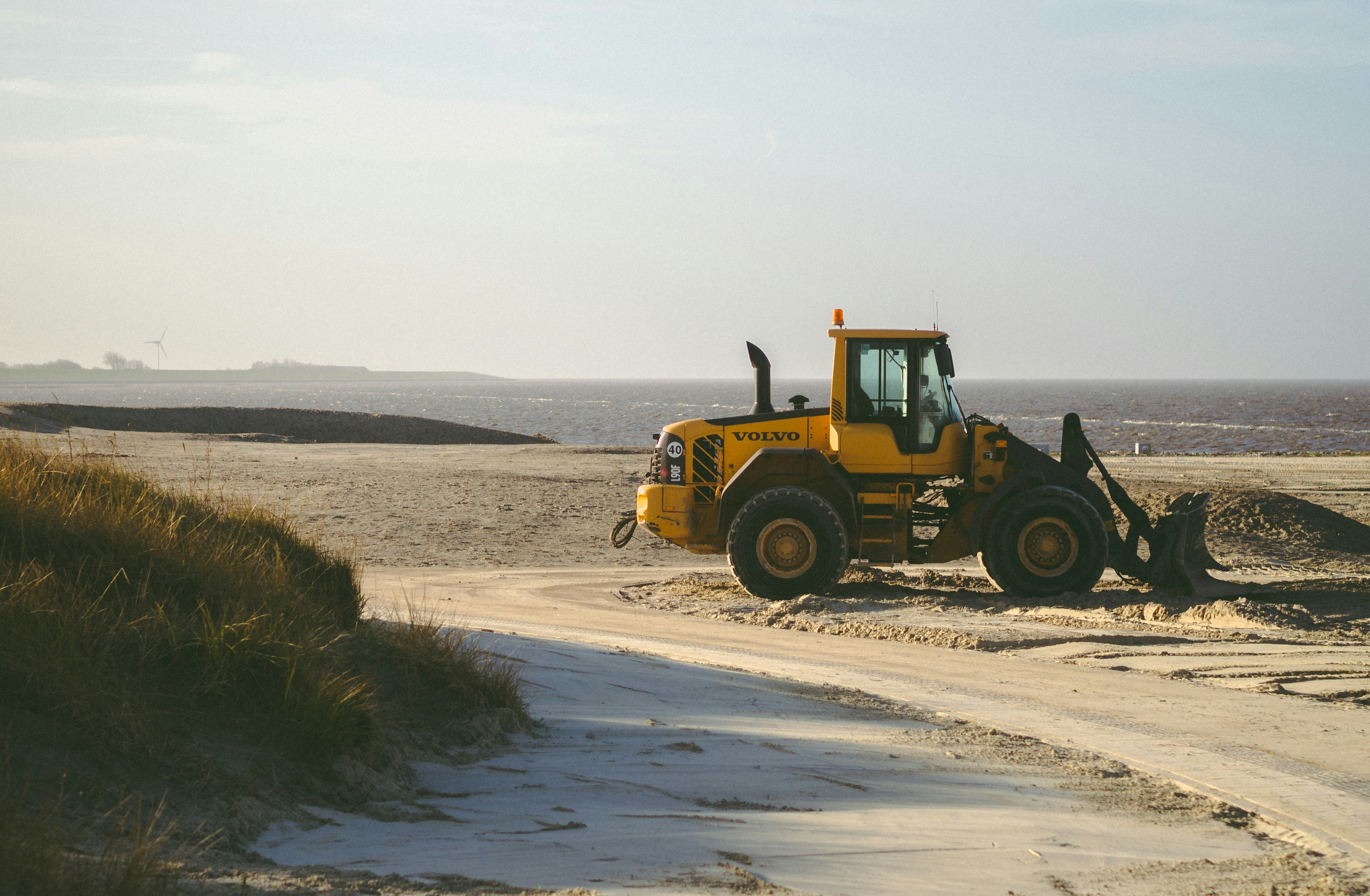 Yellow tractor on a sunny beach