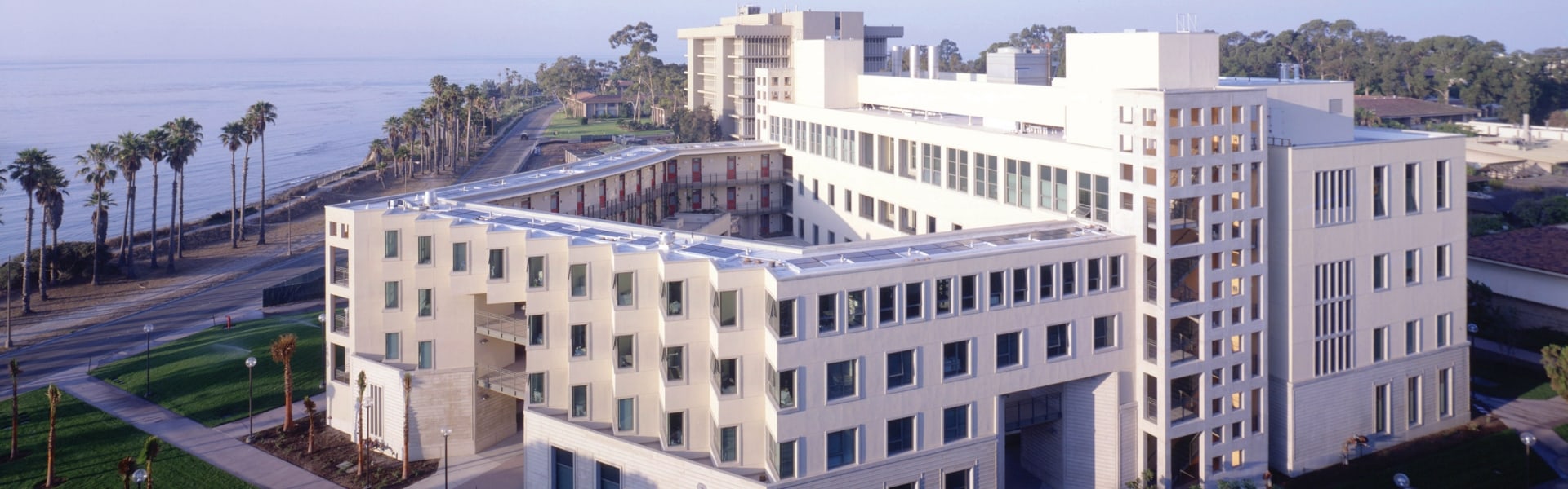 Aerial view of white angular building by oceanside