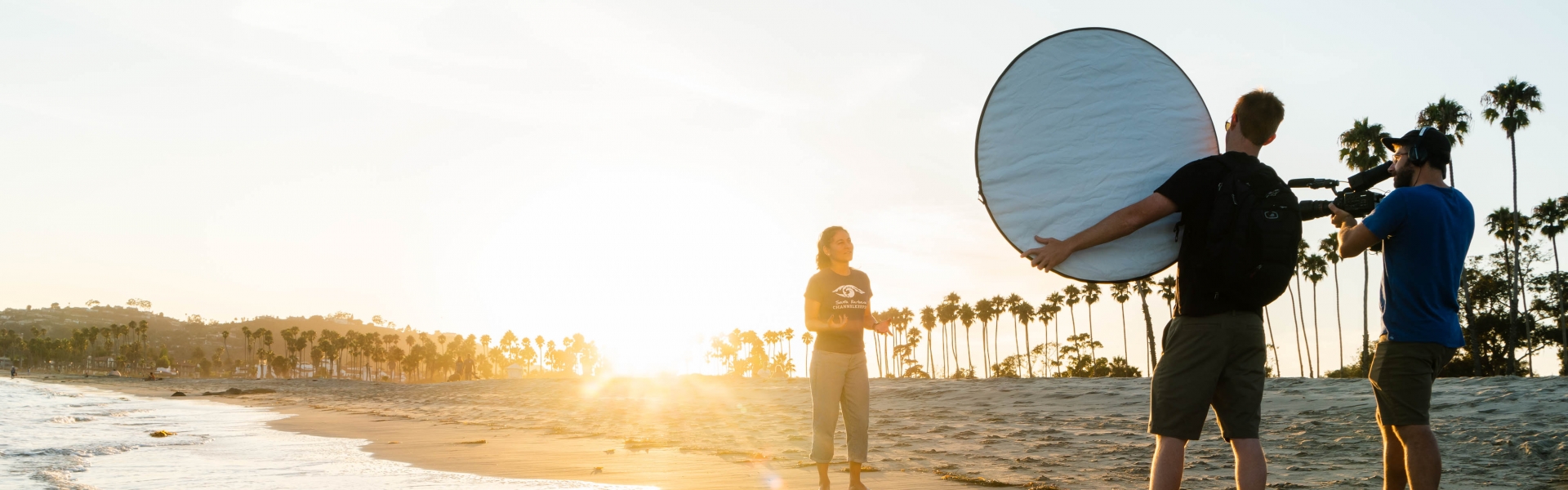 Three students shooting a video on the beach