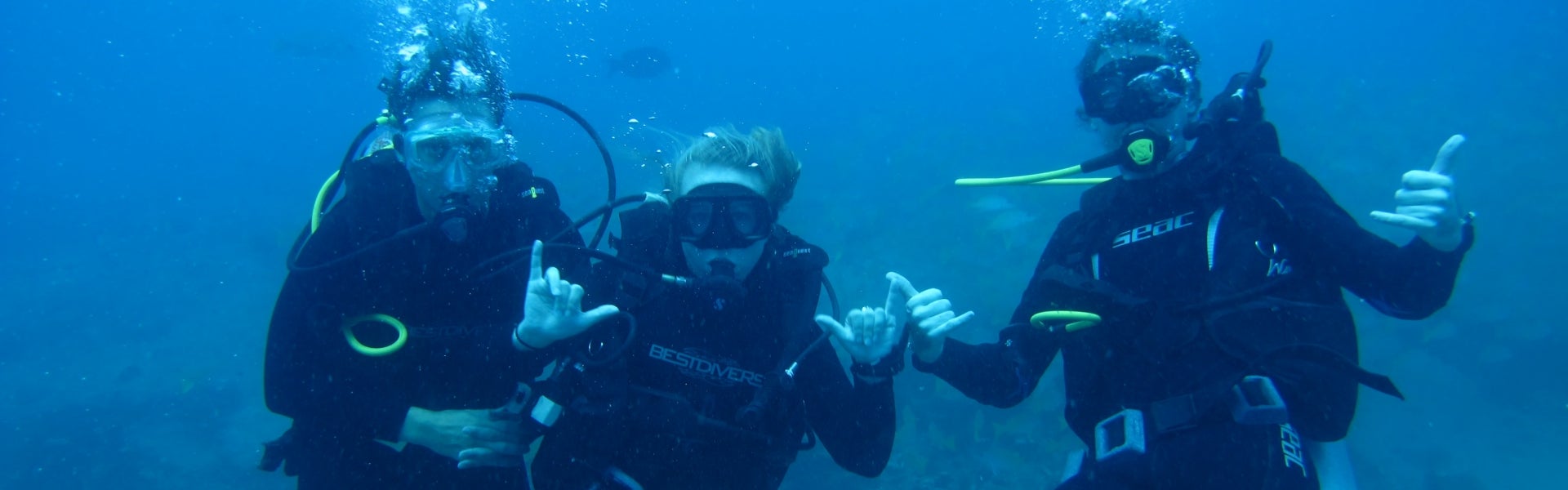 SCUBA divers making hang loose hand signs