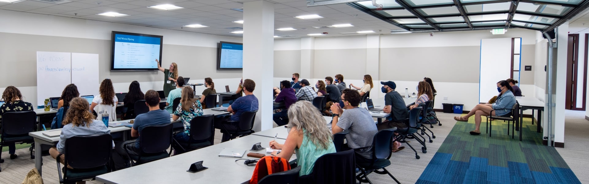 Classroom of people watching an instructor 