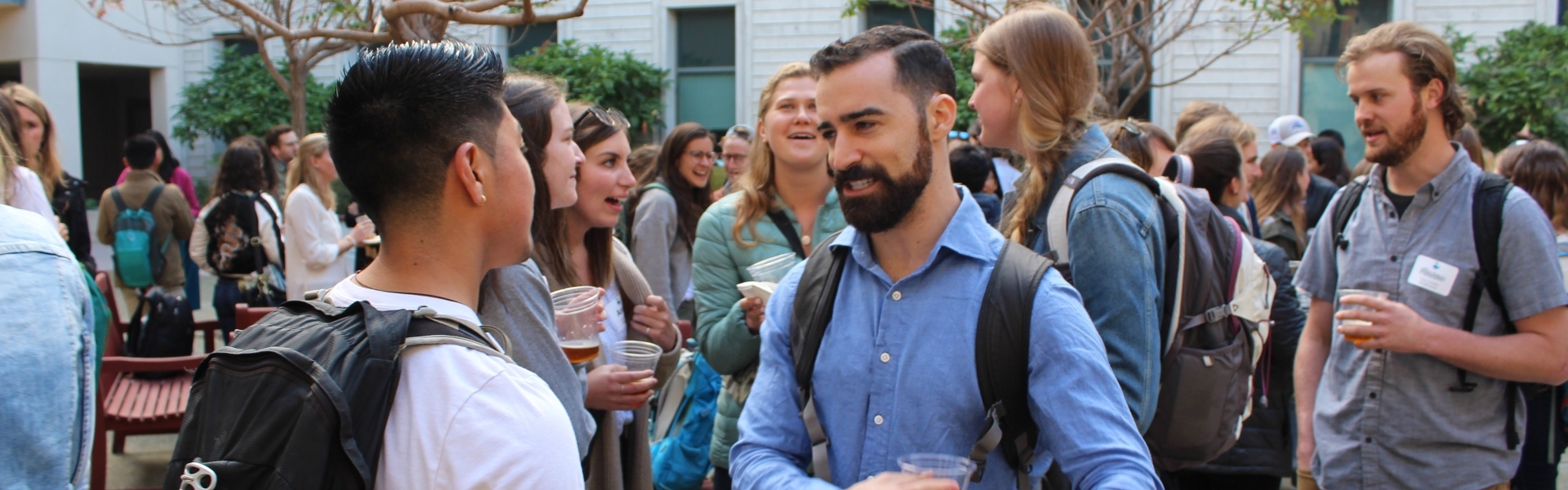 Two students having a conversation at a reception event