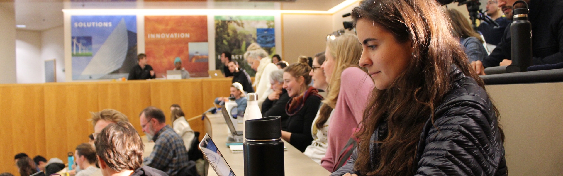 Students sitting in rows in auditorium