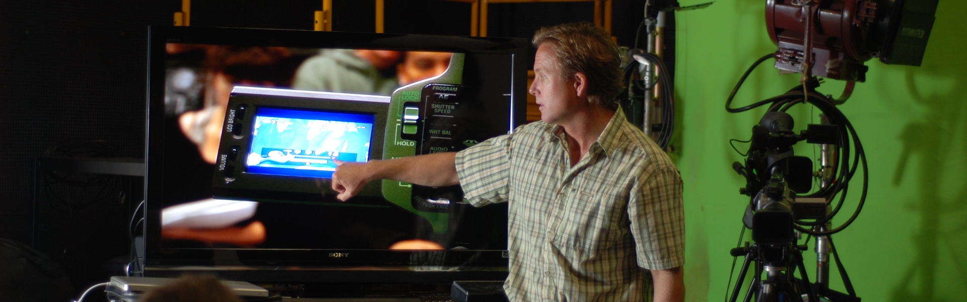 Instructor reviewing video footage on screen in studio