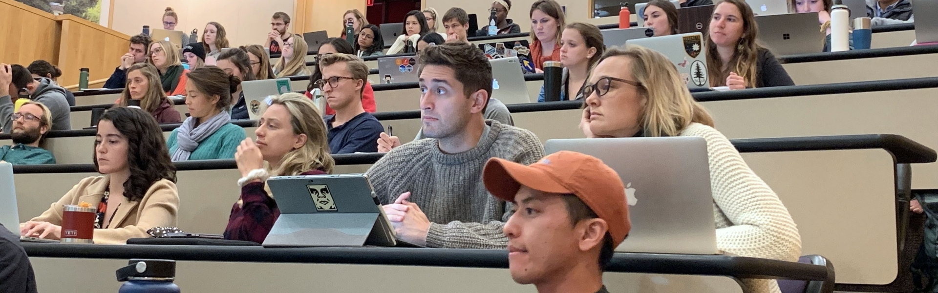 Students sitting in rows in auditorium