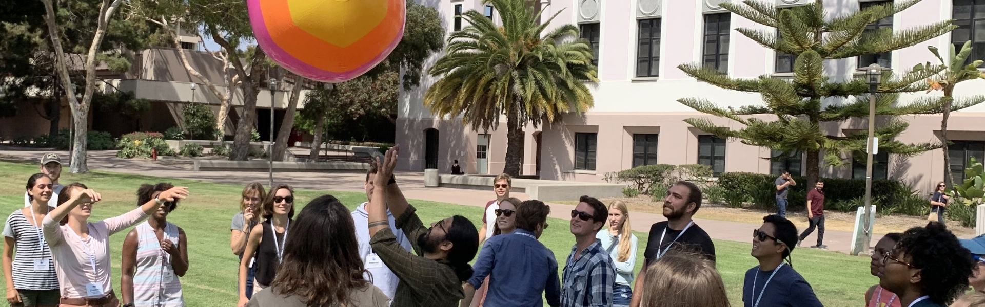 Group of students playing game with inflatable ball