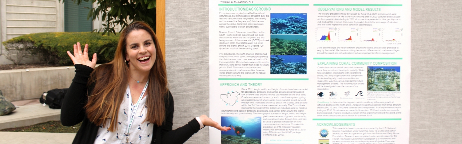 Woman smiling in front of research poster