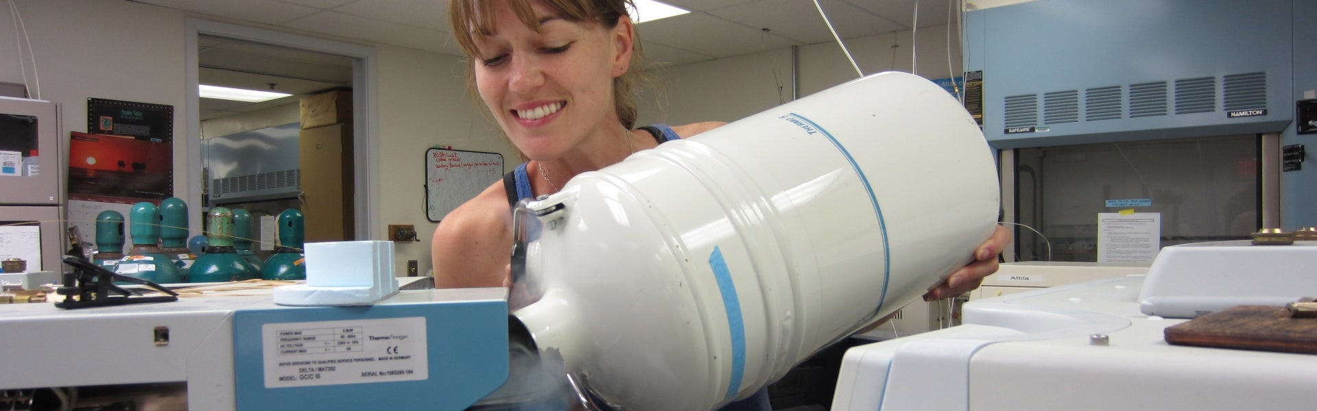 Student pouring liquid nitrogen in a lab