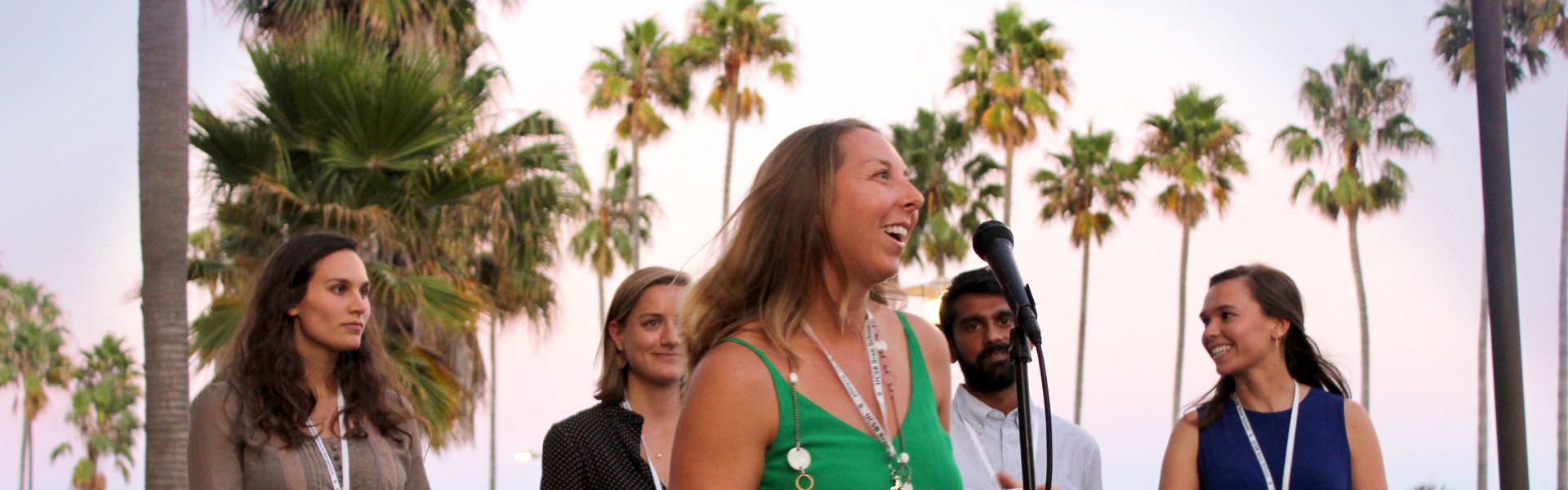 Four people at mics on a stage