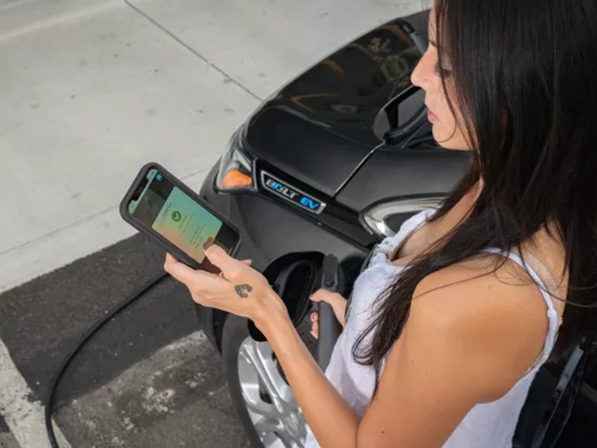 Woman uses the EVMatch app to charge her car
